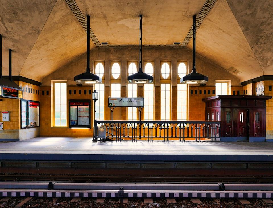 An empty subway station with arched ceiling and lights