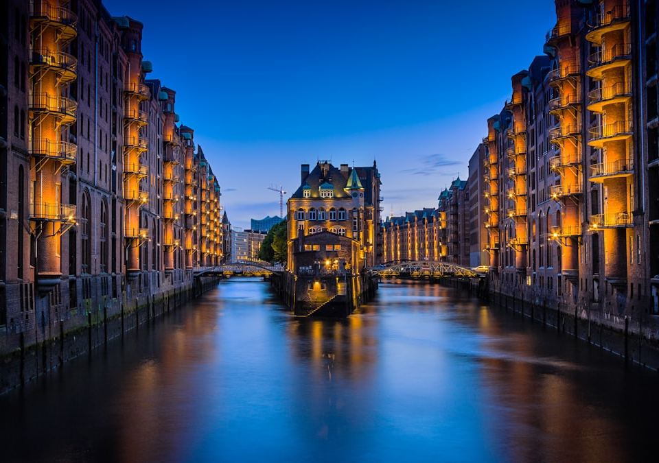 canal between buildings during nighttime